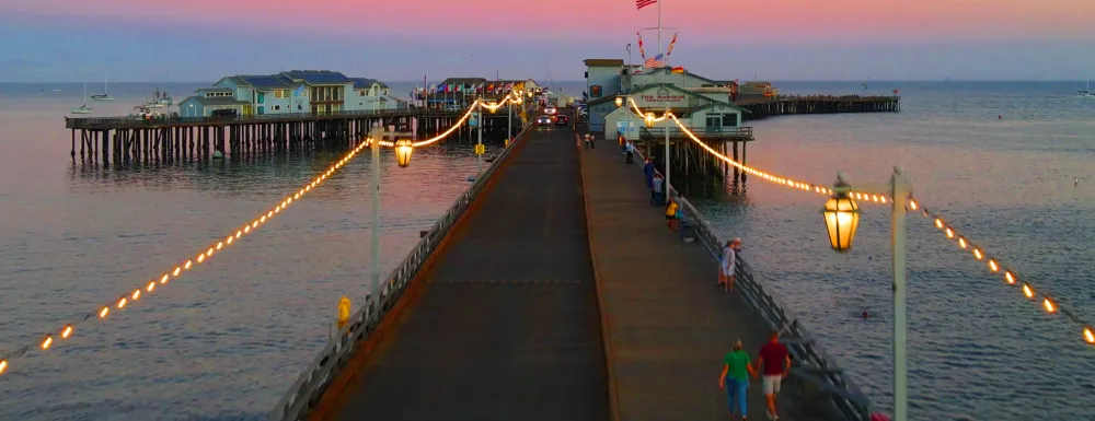 Drone photo of Stearns Wharf at dusk with lights 
