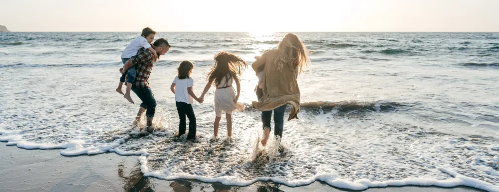 Stock image of a family playing at the beach